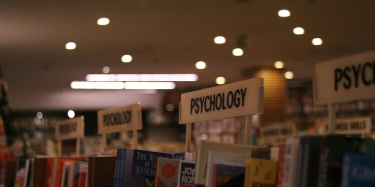 Row of books on a shelf in a library, symbolizing the exploration of psychological concepts